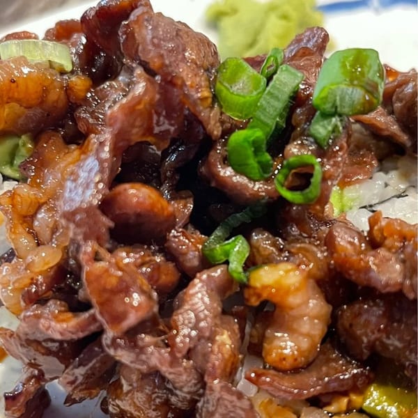 Close-up of Chopstix's Japanese beef dish with green onions and wasabi.